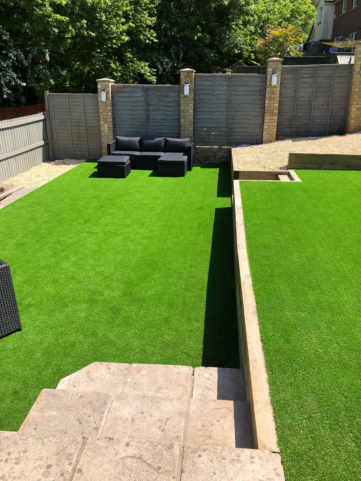 Artificial grass lawn beside a narrow timber-edged path