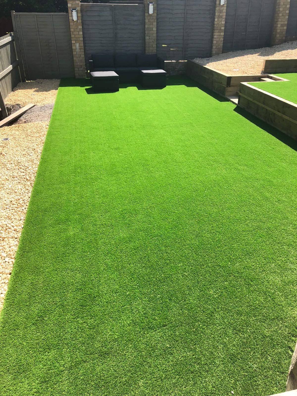 Artificial grass lawn with seating and raised gravel beds