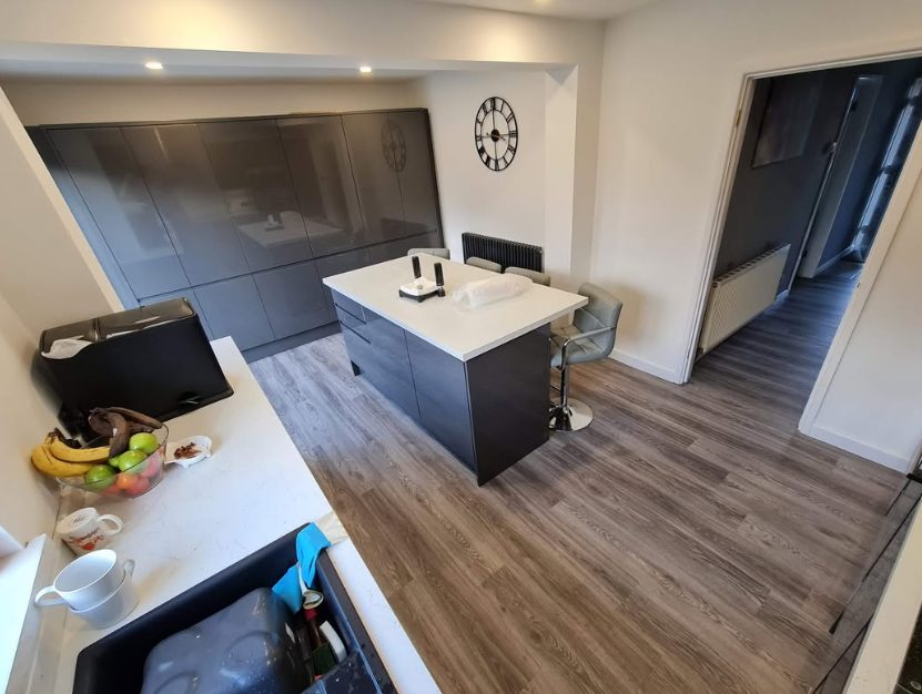 Wood-effect kitchen flooring fitted around a central island