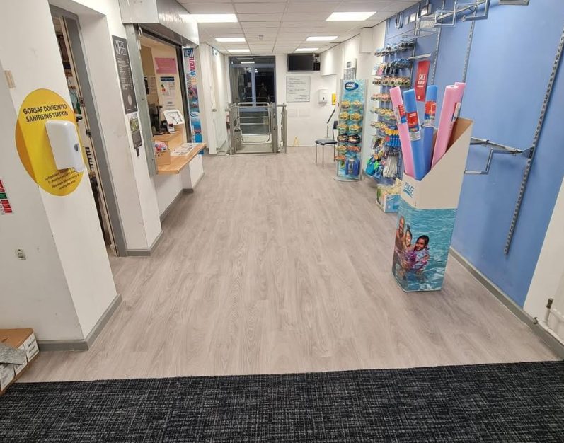 Wood-effect commercial flooring across an indoor corridor