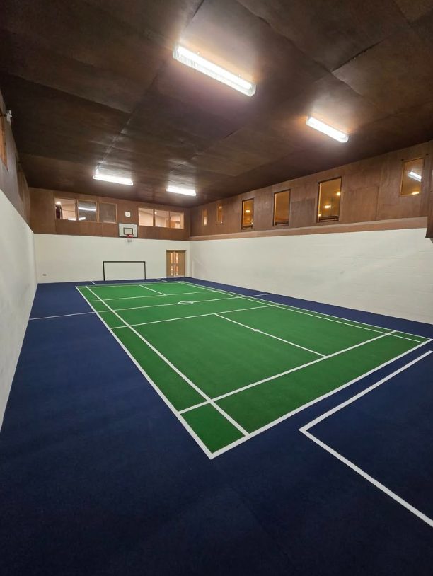 Indoor sports flooring with contrasting badminton court markings