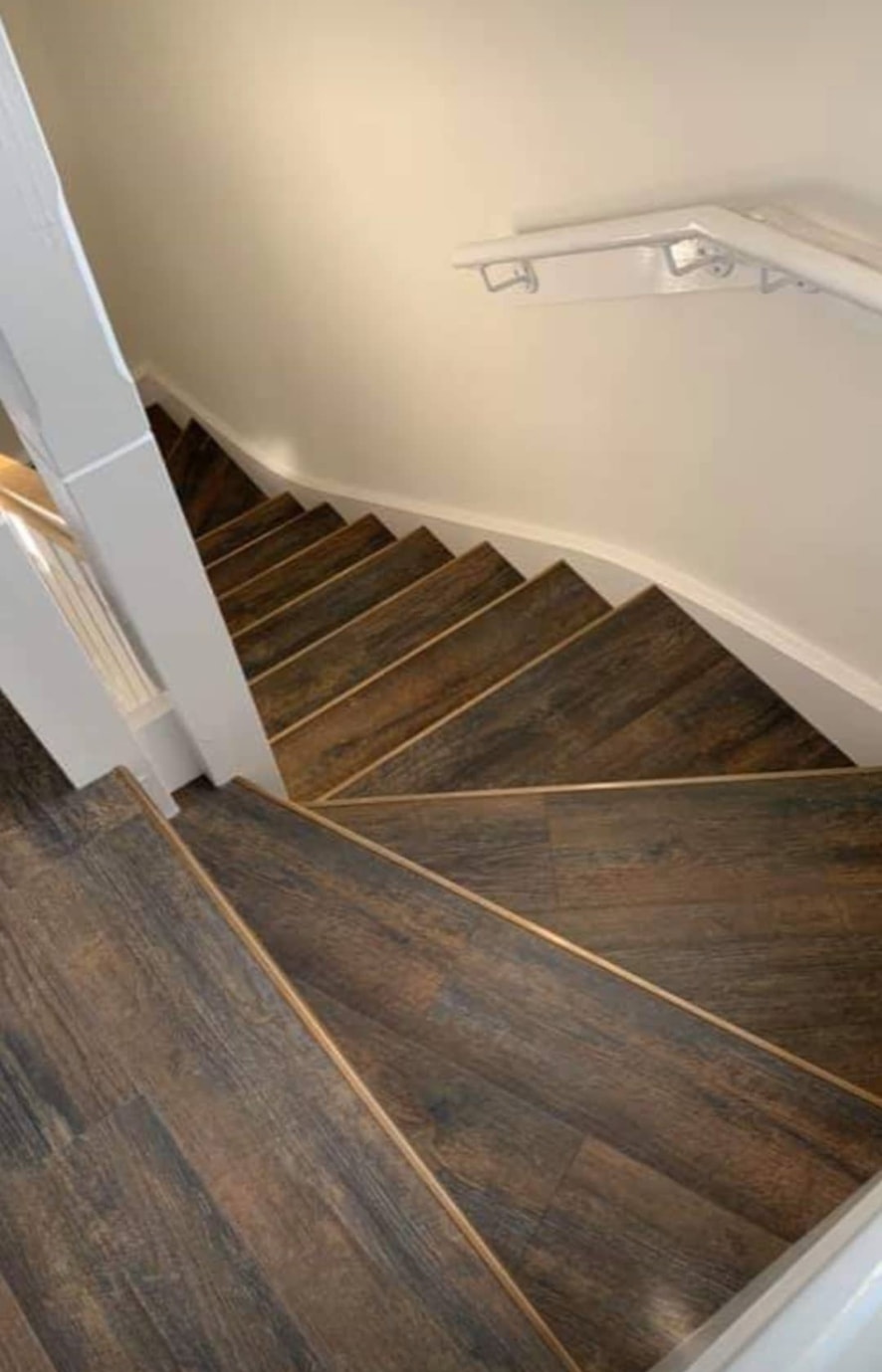Wood-effect flooring on a winding staircase and landing