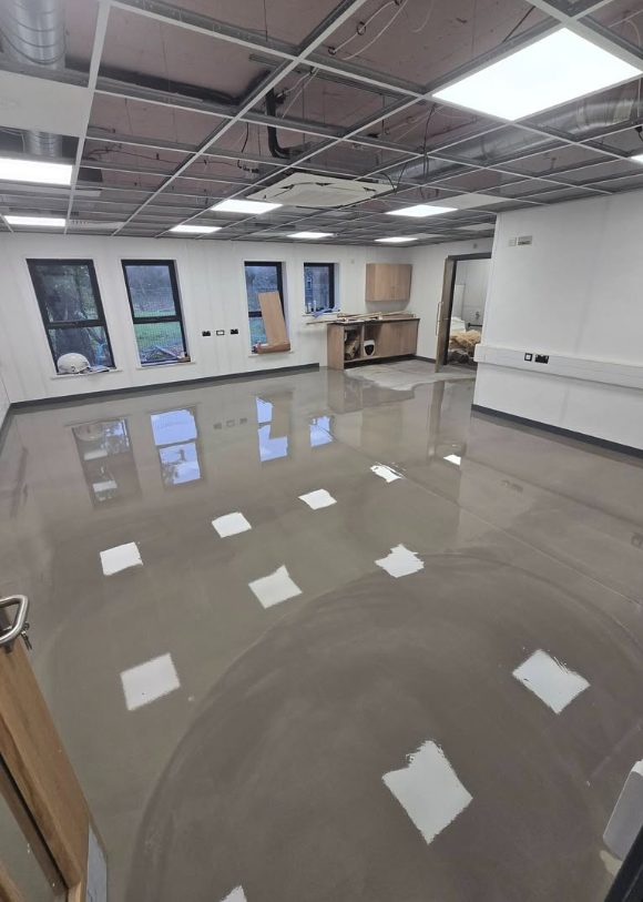 Prepared commercial floor with a smooth reflective surface before finishing