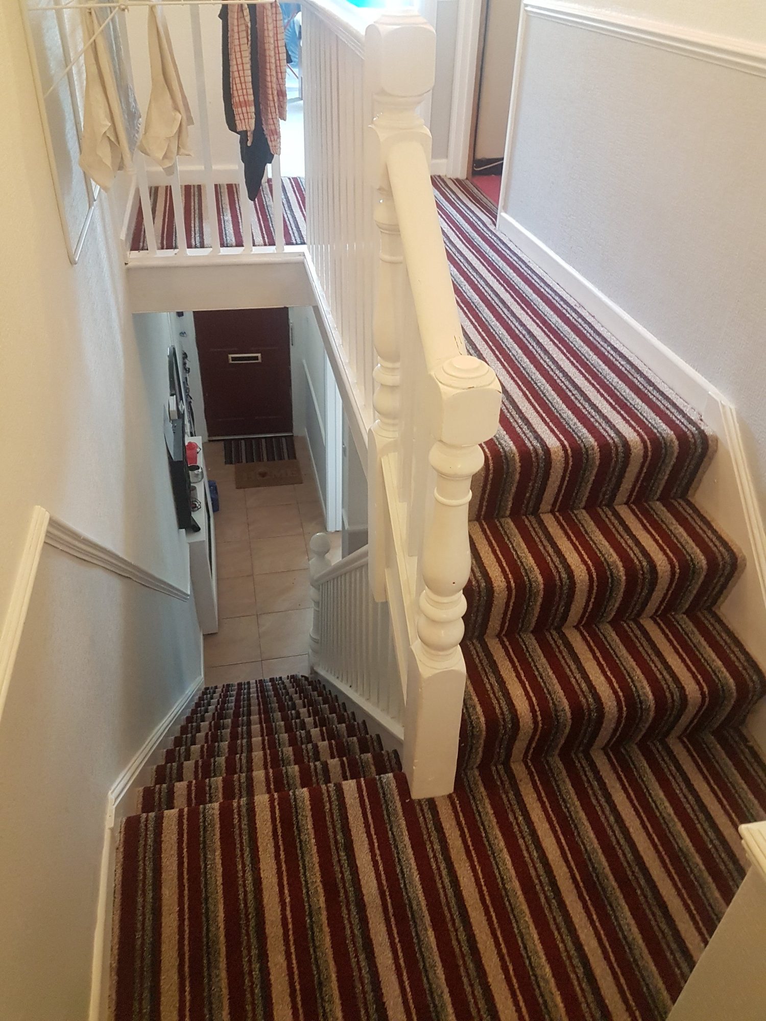 Striped carpet fitted across a staircase and landing