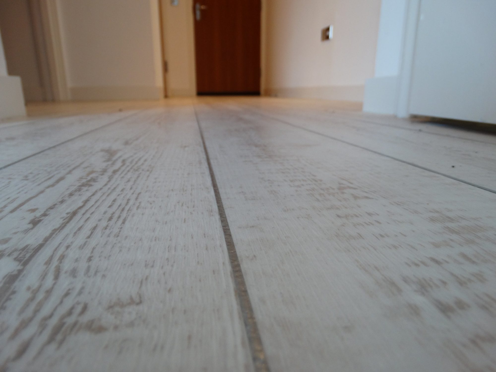 Pale wood-effect planks viewed at floor level