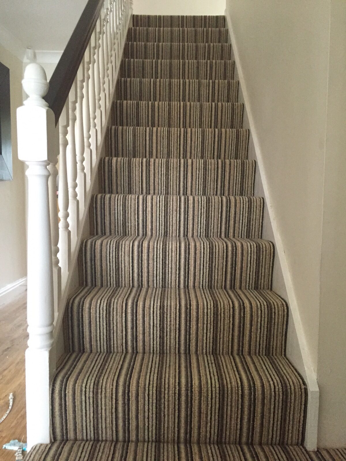 Neutral striped carpet fitted to a staircase