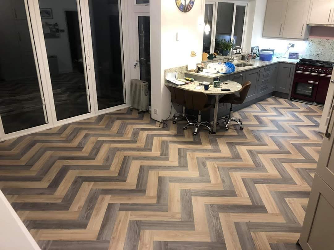 Bespoke chevron-pattern flooring in contrasting shades around dining furniture
