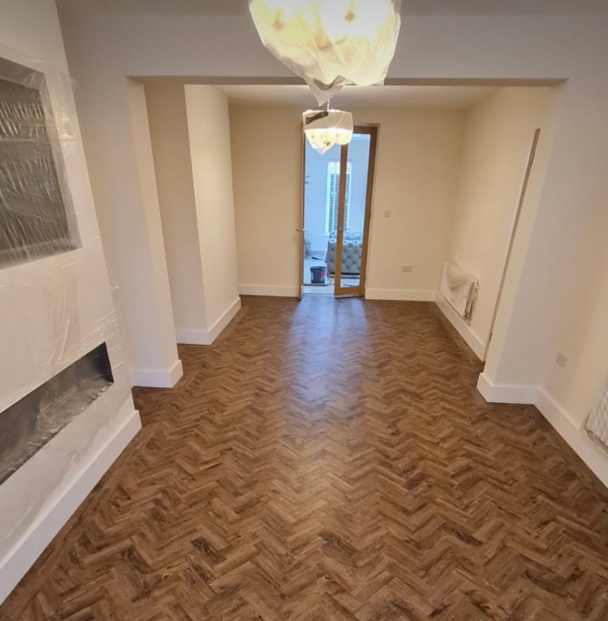 Dark herringbone flooring in a room with a fireplace